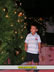 Arubian Boy standing next to Christmas tree
